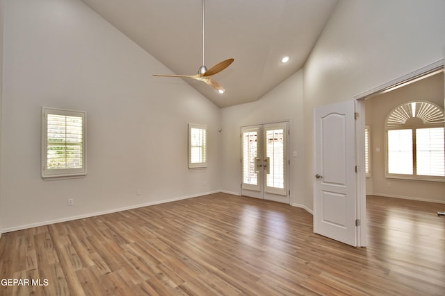1483 Via Appia St, El Paso, TX 79912 - empty room featuring french doors, a ceiling fan, light wood finished floors, high vaulted ceiling, and baseboards
