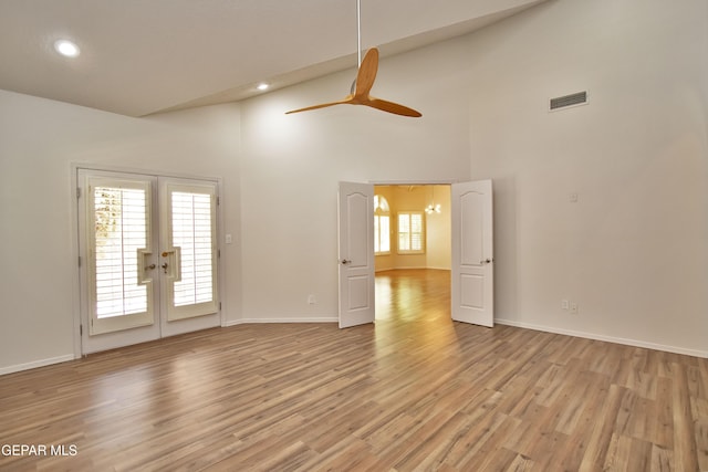 1483 Via Appia St, El Paso, TX 79912 - spare room with french doors, light wood-style flooring, a ceiling fan, high vaulted ceiling, and baseboards