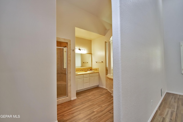 1483 Via Appia St, El Paso, TX 79912 - bathroom featuring a shower stall, wood finished floors, vanity, and baseboards