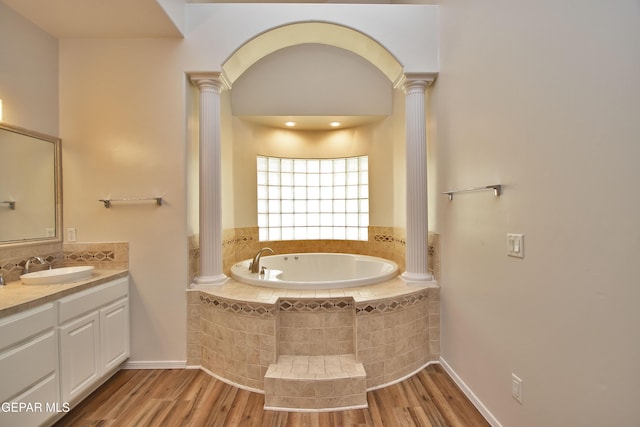 1483 Via Appia St, El Paso, TX 79912 - full bath with decorative columns, wood finished floors, a bath, and vanity