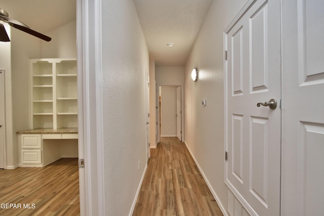 1483 Via Appia St, El Paso, TX 79912 - hallway with light wood finished floors, baseboards, and a desk