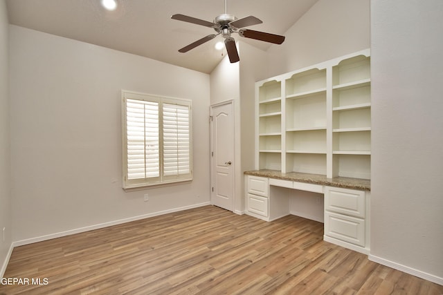 1483 Via Appia St, El Paso, TX 79912 - unfurnished office with built in desk, lofted ceiling, light wood finished floors, a ceiling fan, and baseboards
