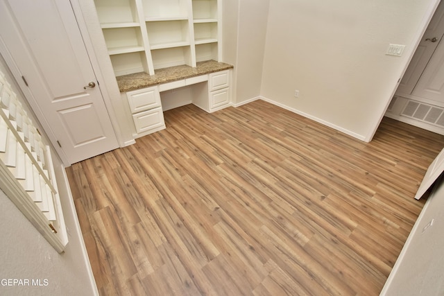 1483 Via Appia St, El Paso, TX 79912 - unfurnished office with built in study area, light wood-style floors, and baseboards