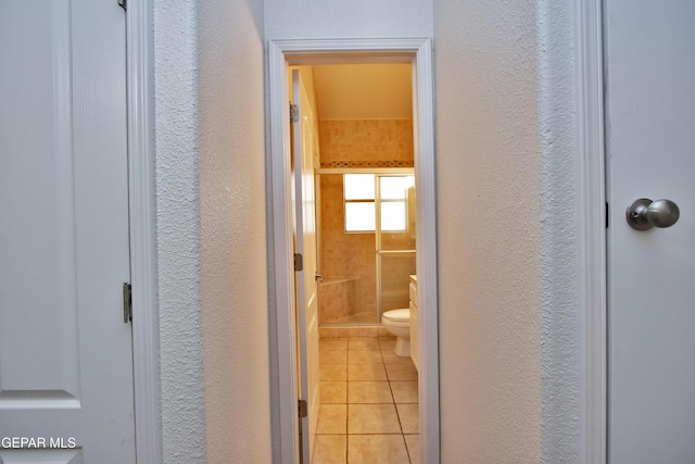 1483 Via Appia St, El Paso, TX 79912 - bathroom with a shower stall, a textured wall, tile patterned floors, and toilet