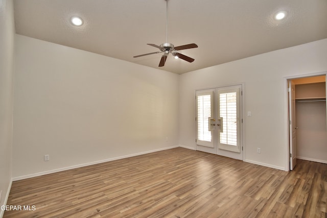 1483 Via Appia St, El Paso, TX 79912 - unfurnished bedroom with french doors, light wood finished floors, baseboards, a walk in closet, and ceiling fan
