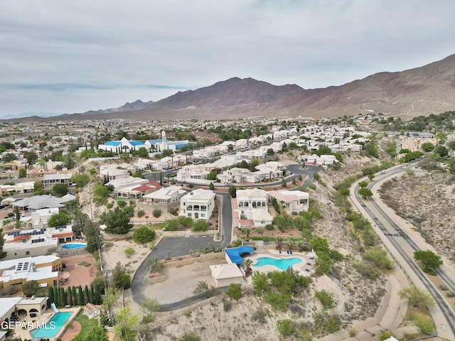 1483 Via Appia St, El Paso, TX 79912 - aerial perspective of suburban area with a pool area and a mountain backdrop