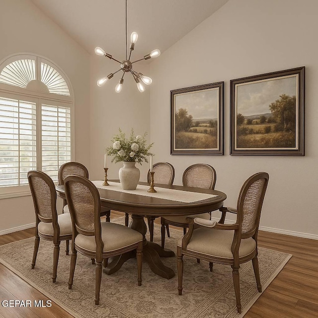 1483 Via Appia St, El Paso, TX 79912 - dining space with a chandelier, wood finished floors, baseboards, and high vaulted ceiling