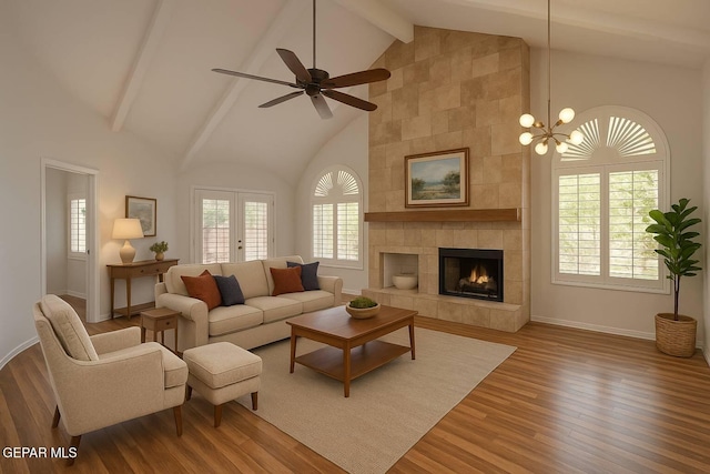 1483 Via Appia St, El Paso, TX 79912 - living room featuring wood finished floors, beamed ceiling, high vaulted ceiling, a tile fireplace, and baseboards