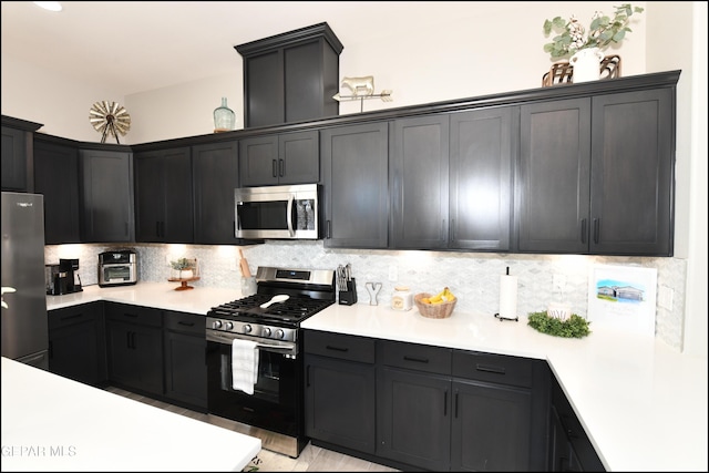 14844 Jack White Ave, El Paso, TX 79938 - kitchen with appliances with stainless steel finishes, light countertops, and backsplash