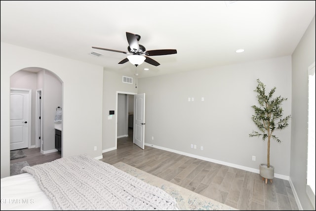 14844 Jack White Ave, El Paso, TX 79938 - unfurnished bedroom with arched walkways, light wood-style floors, recessed lighting, baseboards, and ceiling fan