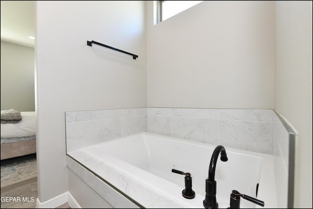 14844 Jack White Ave, El Paso, TX 79938 - bathroom with ensuite bathroom, a bath, and wood finished floors