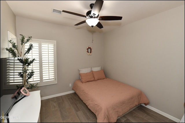 14844 Jack White Ave, El Paso, TX 79938 - bedroom with baseboards, dark wood-type flooring, and a ceiling fan