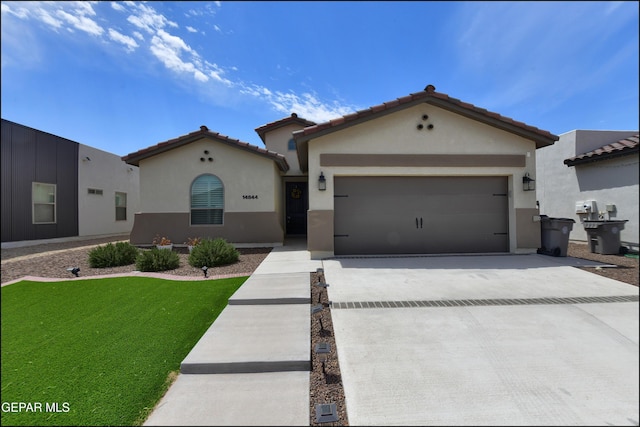 14844 Jack White Ave, El Paso, TX 79938 - mediterranean / spanish-style house featuring stucco siding, driveway, a garage, a front lawn, and a tiled roof