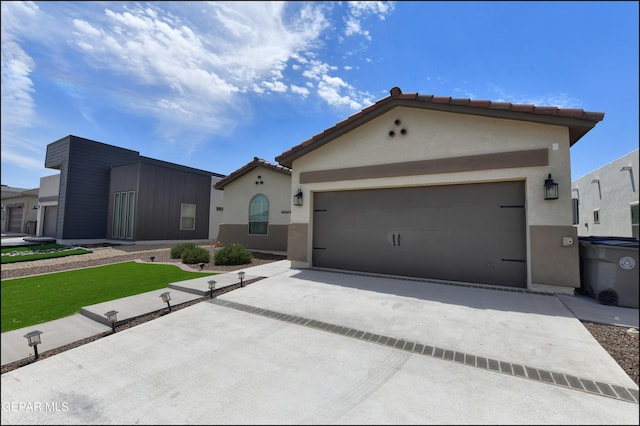 14844 Jack White Ave, El Paso, TX 79938 - mediterranean / spanish-style home featuring concrete driveway, stucco siding, and an attached garage