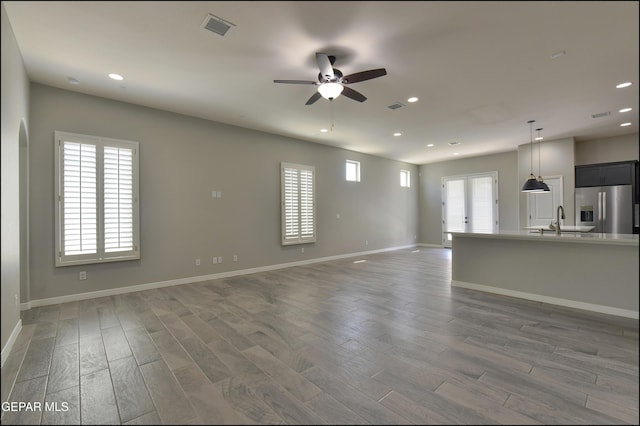 14844 Jack White Ave, El Paso, TX 79938 - unfurnished living room with a ceiling fan, a sink, recessed lighting, wood finished floors, and baseboards