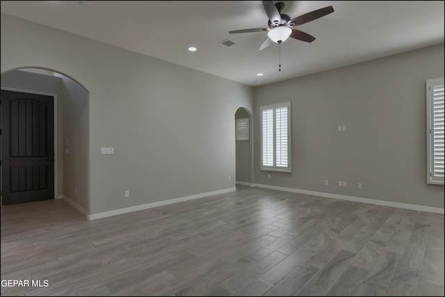 14844 Jack White Ave, El Paso, TX 79938 - unfurnished room featuring arched walkways, a ceiling fan, light wood-type flooring, recessed lighting, and baseboards