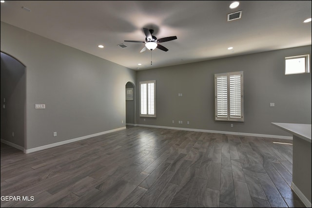 14844 Jack White Ave, El Paso, TX 79938 - empty room featuring ceiling fan, recessed lighting, dark wood-type flooring, baseboards, and arched walkways