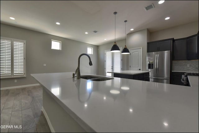 14844 Jack White Ave, El Paso, TX 79938 - kitchen featuring stainless steel fridge with ice dispenser, a sink, a kitchen island, recessed lighting, and tasteful backsplash