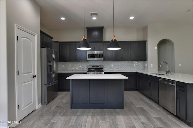 14844 Jack White Ave, El Paso, TX 79938 - kitchen featuring stainless steel appliances, a sink, light countertops, backsplash, and recessed lighting