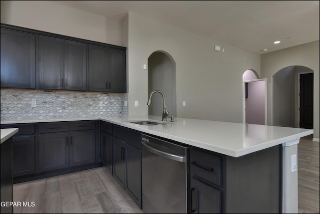 14844 Jack White Ave, El Paso, TX 79938 - kitchen with dishwasher, a sink, a peninsula, arched walkways, and tasteful backsplash
