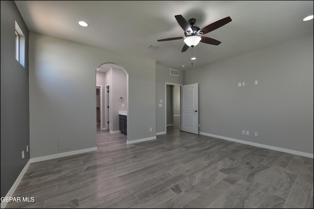 14844 Jack White Ave, El Paso, TX 79938 - unfurnished bedroom featuring arched walkways, recessed lighting, baseboards, ensuite bathroom, and a ceiling fan
