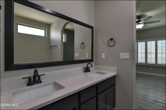 14844 Jack White Ave, El Paso, TX 79938 - bathroom featuring a ceiling fan, double vanity, wood finished floors, and baseboards