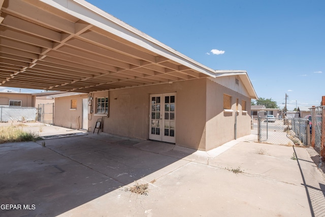 933 Duskin Dr, El Paso, TX 79907 - back of property with a carport, fence, a patio area, and stucco siding