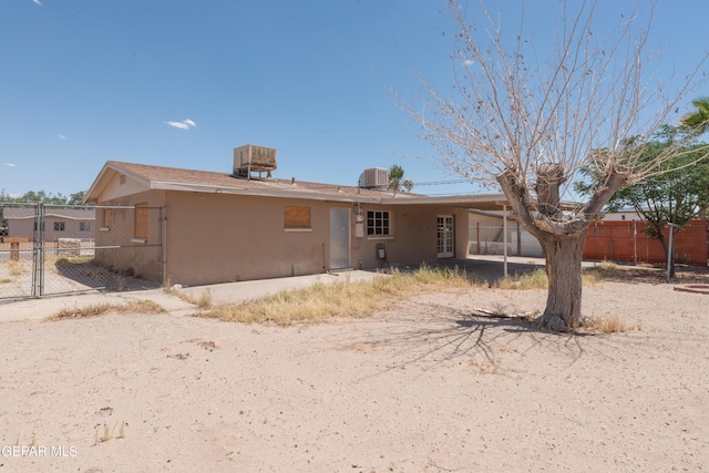 933 Duskin Dr, El Paso, TX 79907 - rear view of house featuring fence, stucco siding, a gate, and cooling unit