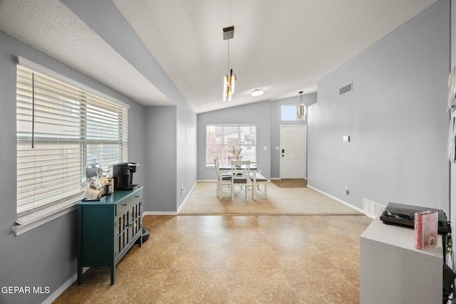 dining room with light floors, baseboards, and vaulted ceiling