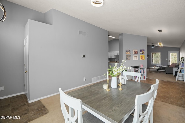 dining room with lofted ceiling, a ceiling fan, and baseboards