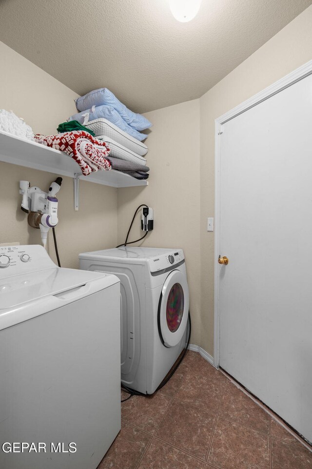 clothes washing area featuring separate washer and dryer and tile patterned floors