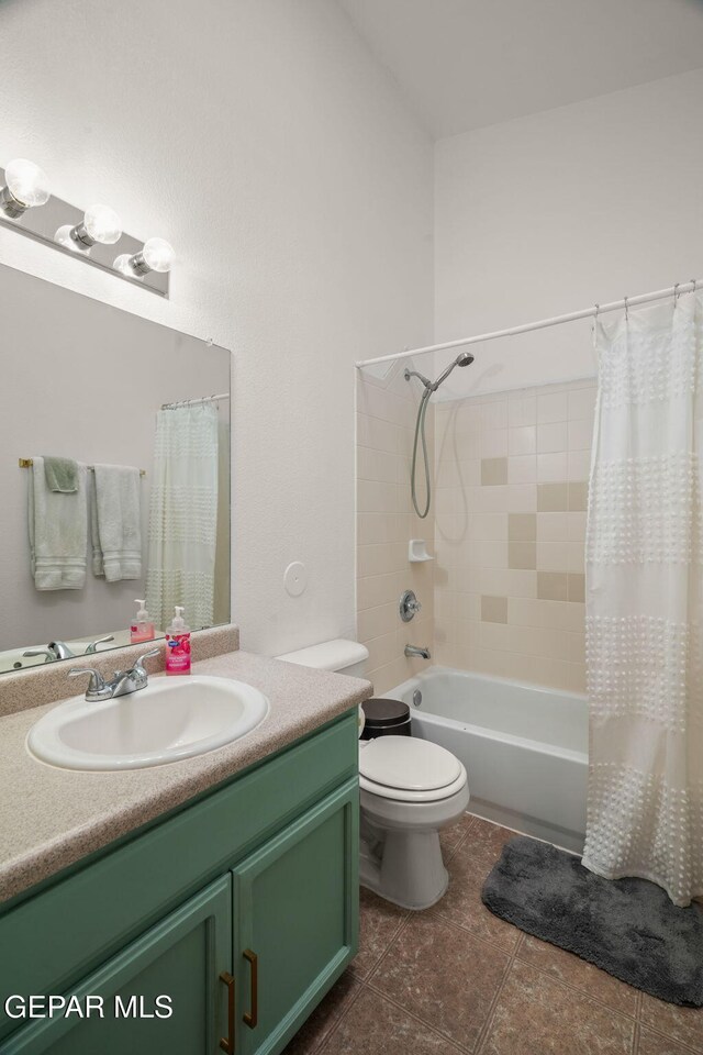 bathroom featuring vanity, shower / bath combo, toilet, and tile patterned floors
