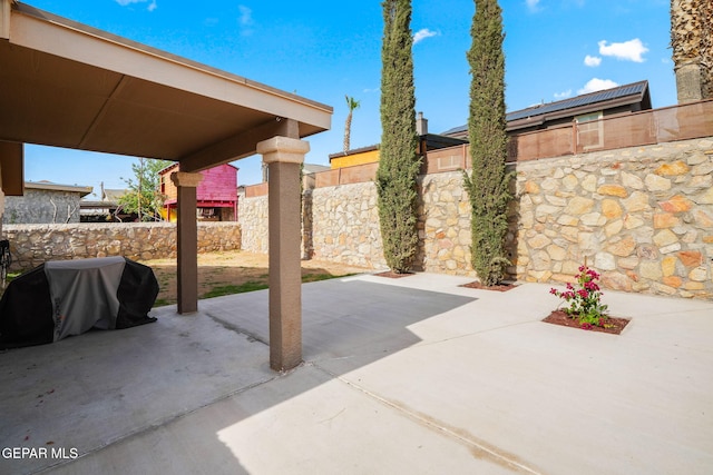 view of patio / terrace with a fenced backyard and a grill
