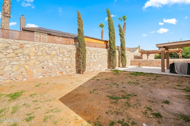 fenced backyard featuring a pergola and a patio
