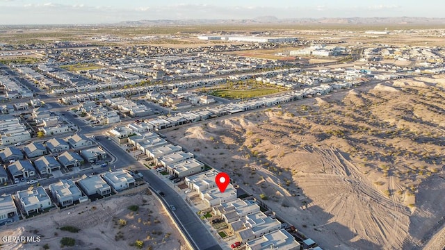 aerial overview of property's location with a mountainous background and nearby suburban area
