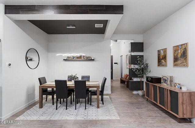 dining area featuring wood finished floors and baseboards