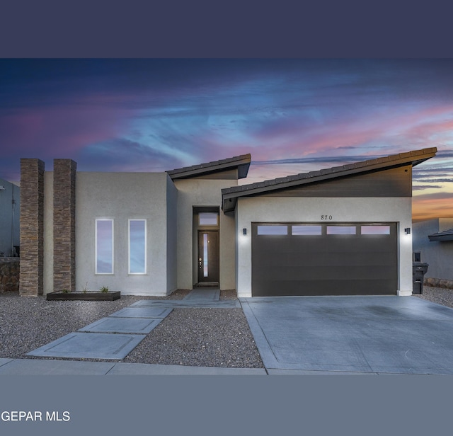 870 Airship St, El Paso, TX 79938 - view of front facade with stucco siding, an attached garage, and concrete driveway