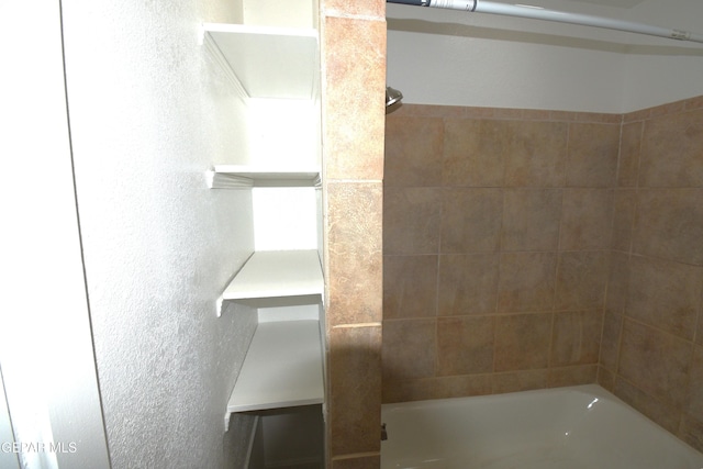 9207 Montgomery Dr, El Paso, TX 79924 - bathroom with a textured wall and shower / bath combination