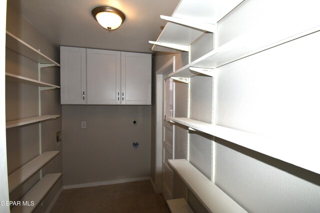 9207 Montgomery Dr, El Paso, TX 79924 - laundry area with hookup for an electric dryer, cabinet space, tile patterned flooring, and baseboards