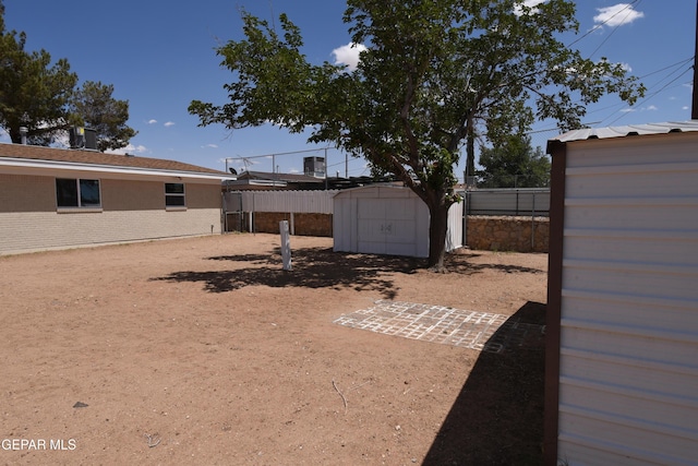 9207 Montgomery Dr, El Paso, TX 79924 - view of yard featuring a storage unit, an outbuilding, and fence