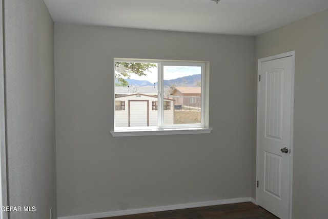 9207 Montgomery Dr, El Paso, TX 79924 - unfurnished room with a mountain view, dark wood-style flooring, and baseboards