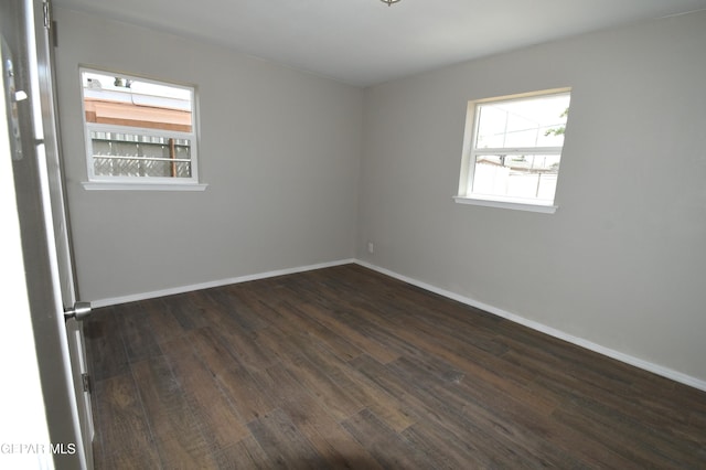 9207 Montgomery Dr, El Paso, TX 79924 - spare room featuring dark wood-style flooring and baseboards