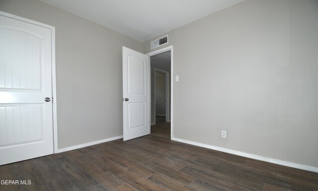 9207 Montgomery Dr, El Paso, TX 79924 - unfurnished bedroom featuring dark wood-style flooring and baseboards