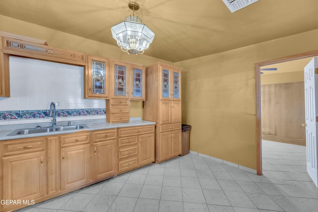 3571 Rebecca Ln, El Paso, TX 79938 - kitchen featuring a sink, light countertops, a chandelier, glass insert cabinets, and pendant lighting