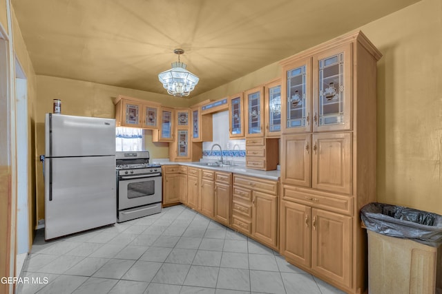3571 Rebecca Ln, El Paso, TX 79938 - kitchen with appliances with stainless steel finishes, a sink, light countertops, a chandelier, and hanging light fixtures