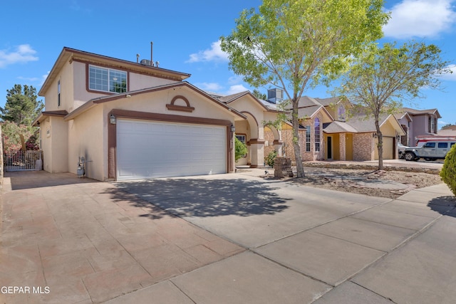view of front of property with stucco siding, concrete driveway, and a garage