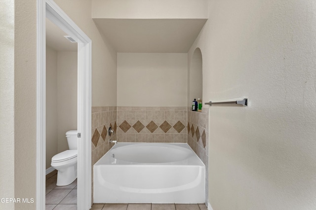 bathroom featuring a bath, toilet, and tile patterned floors