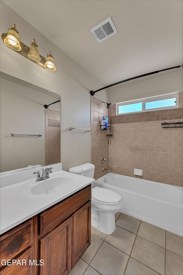 full bathroom featuring toilet, tile patterned floors, washtub / shower combination, and vanity
