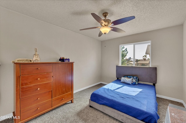 carpeted bedroom featuring baseboards, a textured ceiling, and ceiling fan