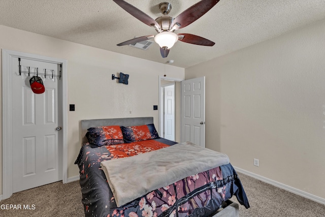 carpeted bedroom featuring a textured ceiling, baseboards, and ceiling fan